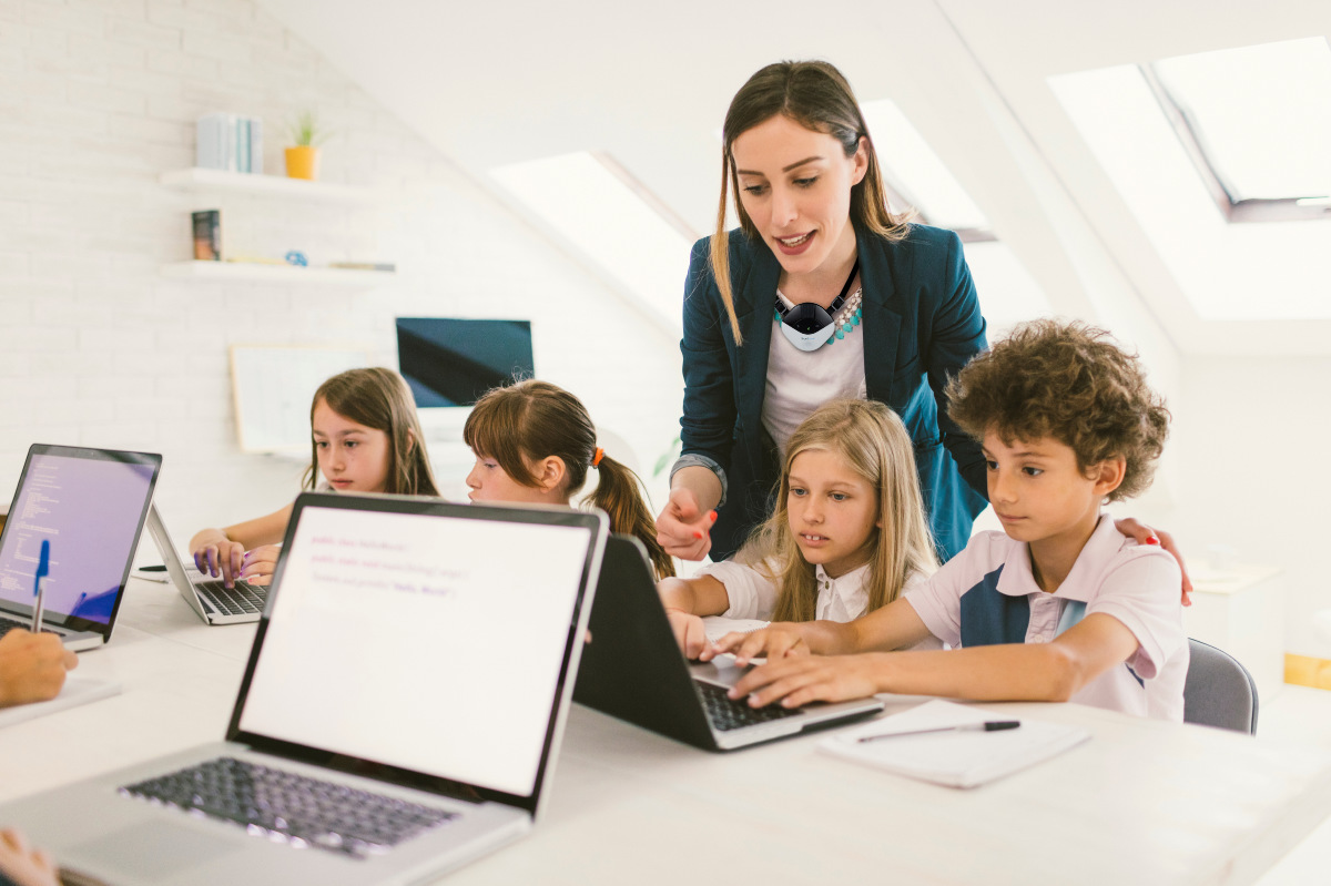 Teacher and students with laptops