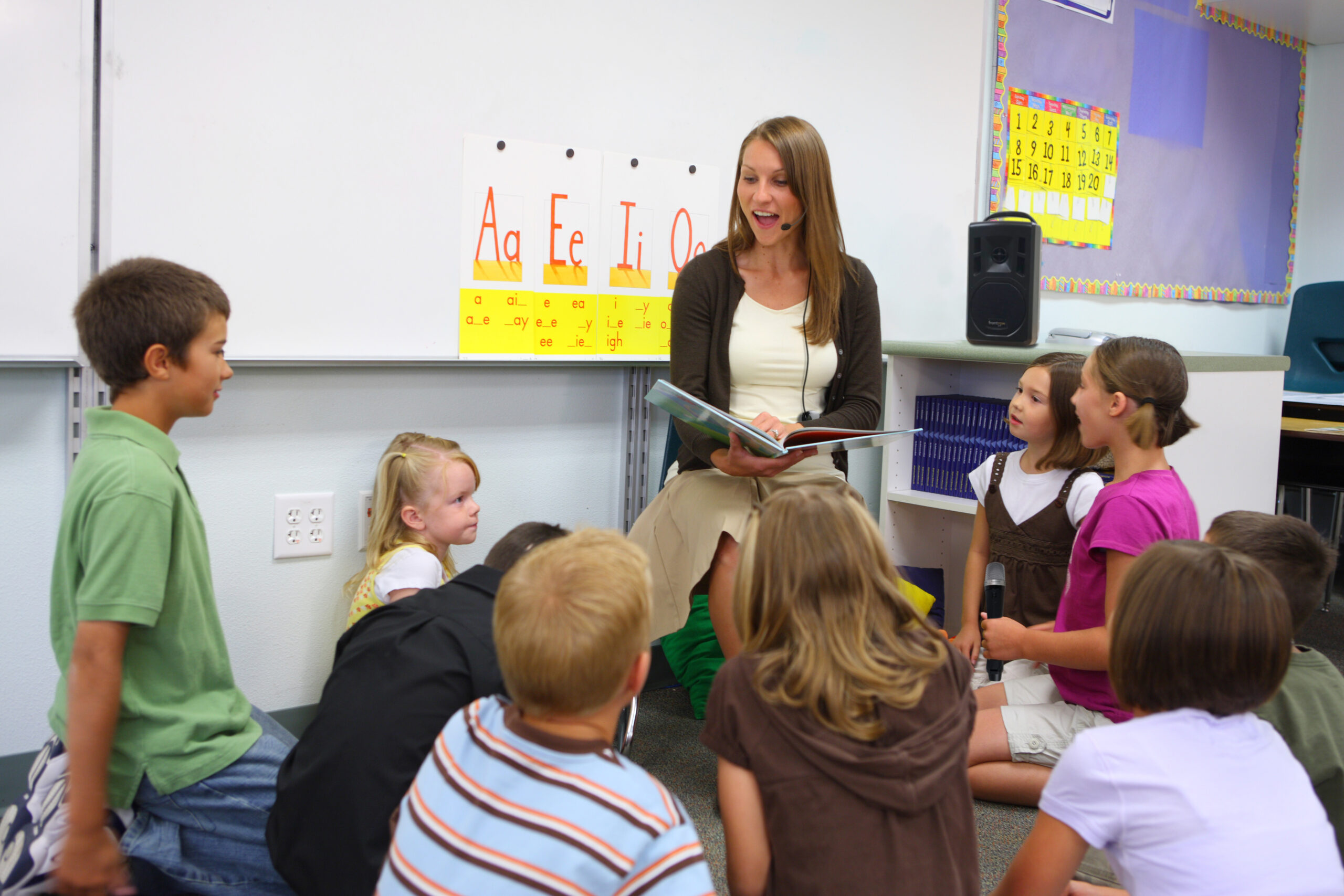 Teacher reading book to class with sound amplification